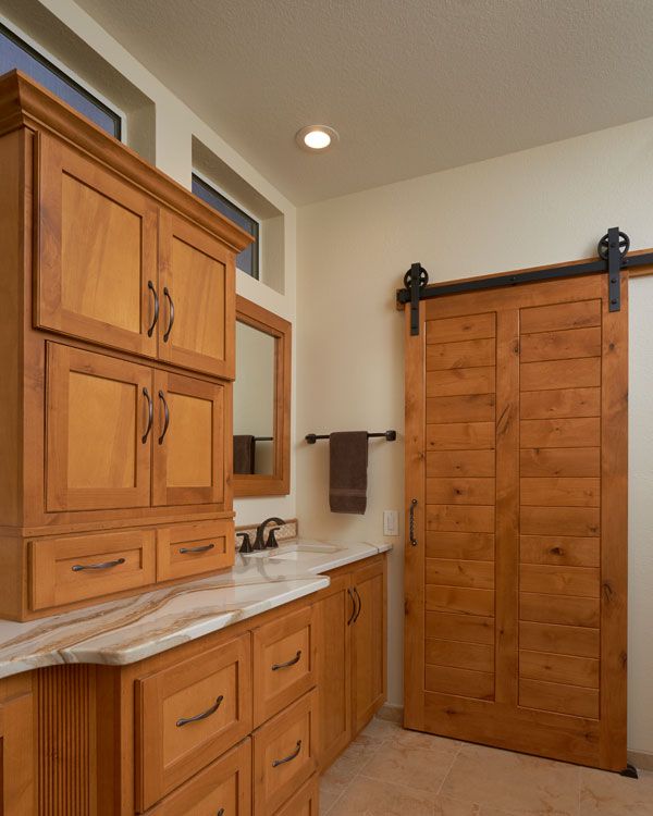 Light colored cabinets in bathroom with 1 sink. 