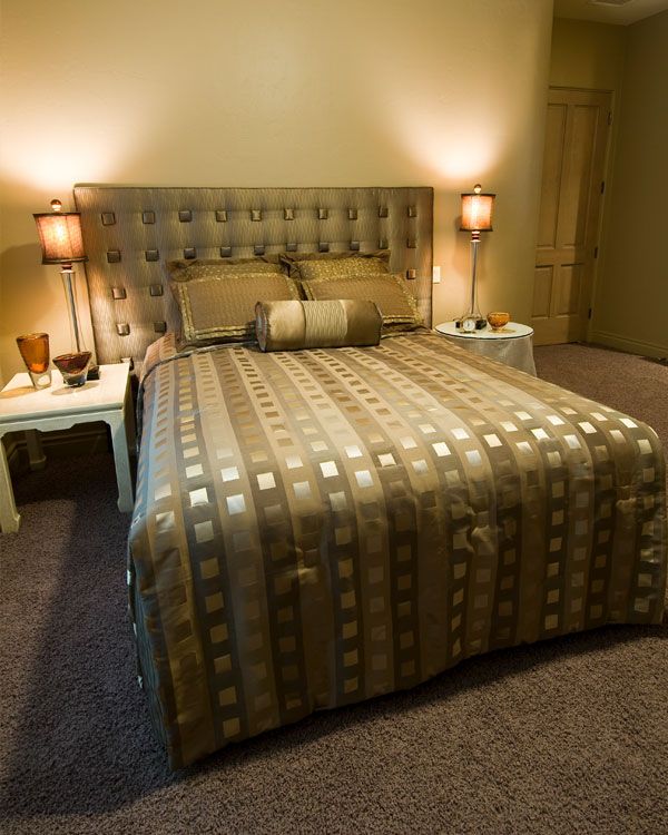 Bedroom with dark carpet and light green walls. 