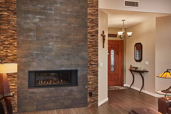 Fireplace and dark wooden floors with light colored walls. 