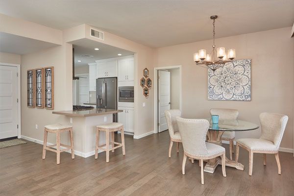 Wooden floor with light colored walls and seats. 