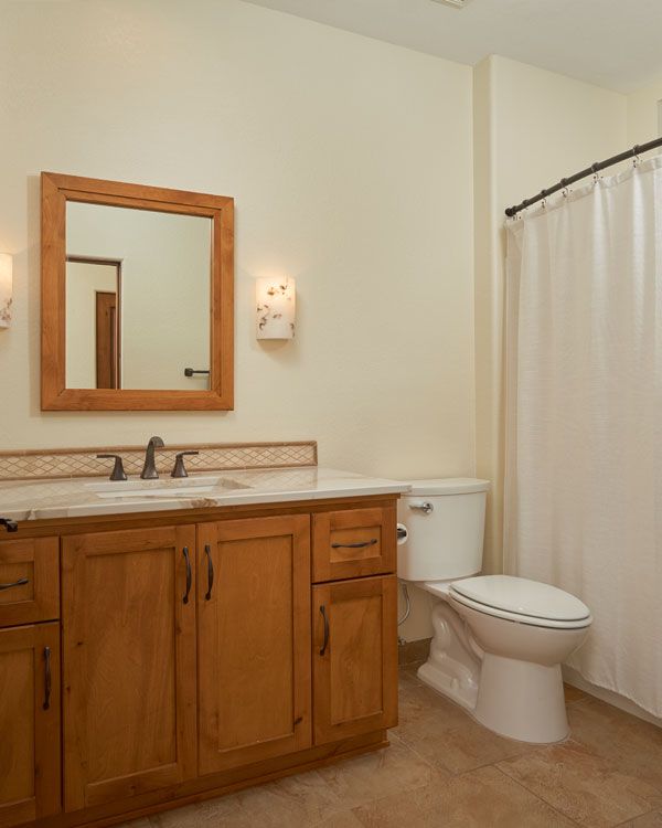Tile floor with light colored walls. 