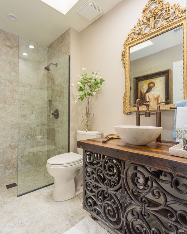 wooden sink counter top next to toilet and light colored walls and floor. 