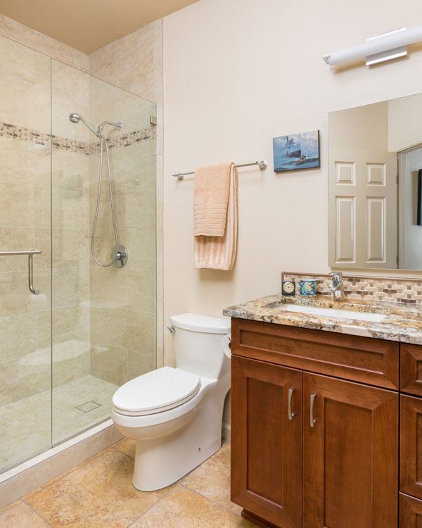 Light colored walls with marble sink counter top in bathroom. 
