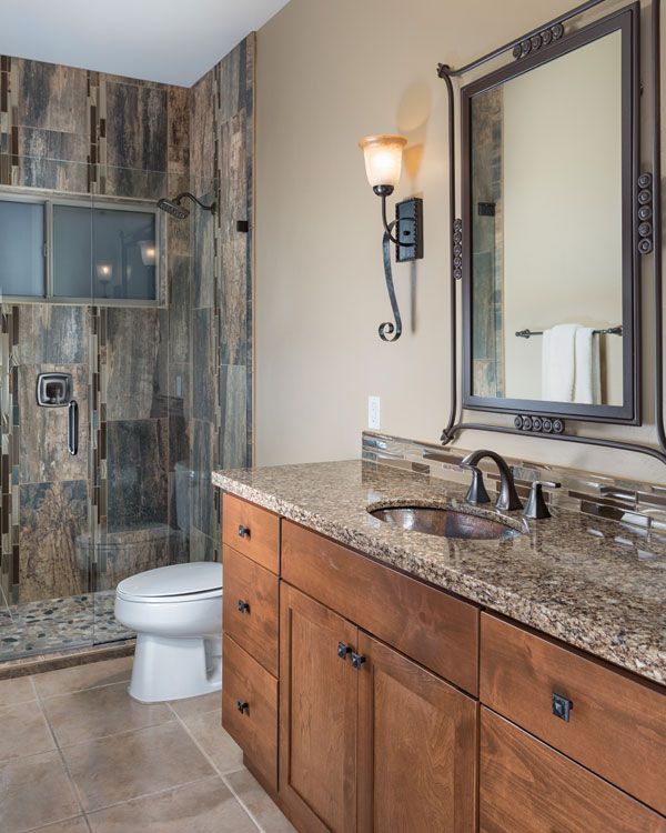 Tile floor and dark sink counter top in bathroom. 
