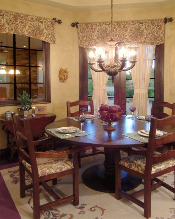 Yellow walls with dark wooden table. 