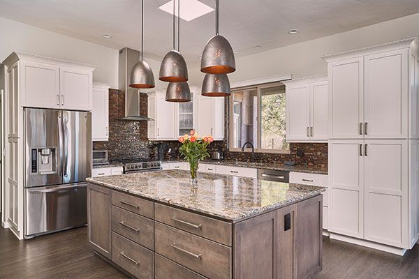Dark wooden floors with white cabinets. 
