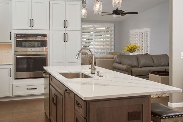 White counter tops around sink with white cabinets. 