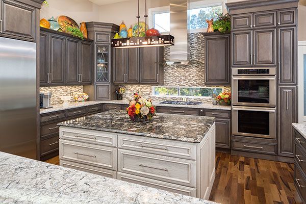 Dark wooden floors and marbled kitchen counter tops. 