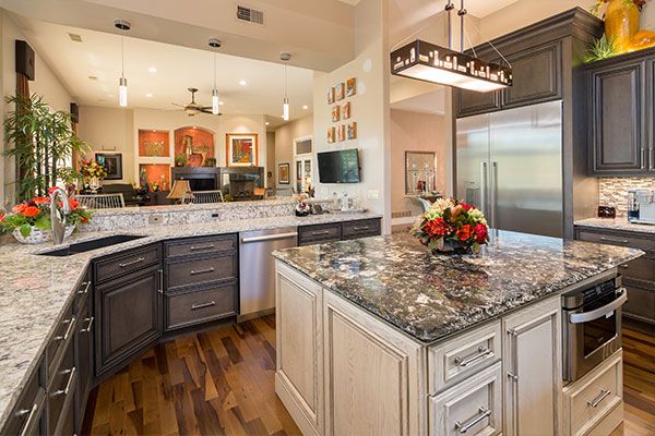 Kitchen island with light above with marbled counter tops. 