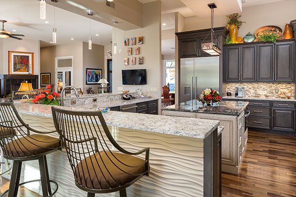 Kitchen with dark wooden floors, counter tops, and dark cabinets. 