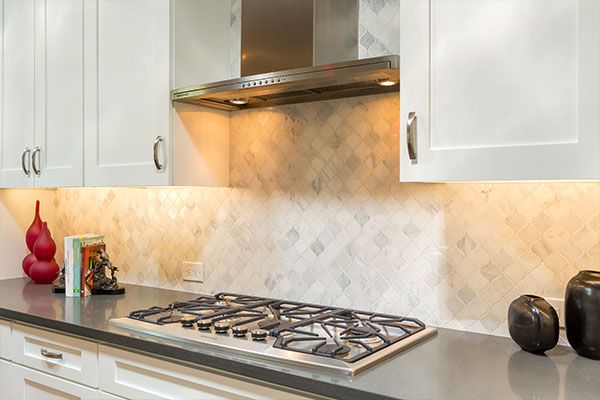 White kitchen cabinets around stove top. 