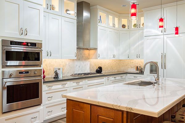 white cabinets with white kitchen island counter top. 