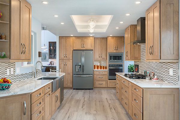 Wooden cabinets with light blue kitchen ceiling. 