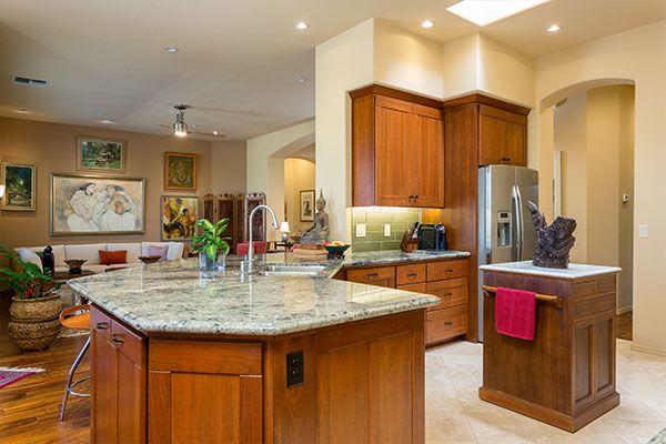 Counter tops and small kitchen island with light colored walls. 