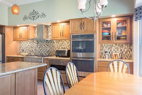 Light wood cabinets and kitchen table. 