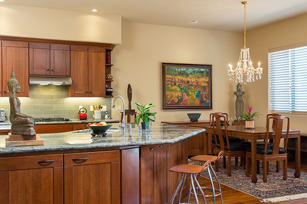 Wooden floor with rug under kitchen table. 
