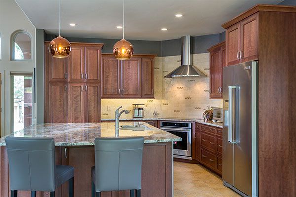 Dark red wooden cabinets with grey seats. 