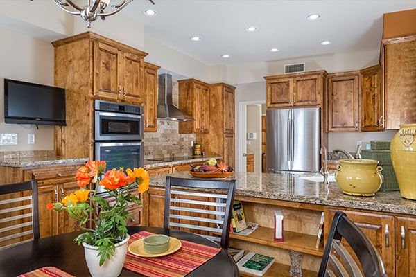 Light colored walls with black kitchen table. 