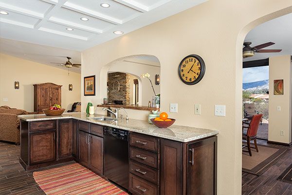 dark colored kitchen cabinets with light colored walls. 