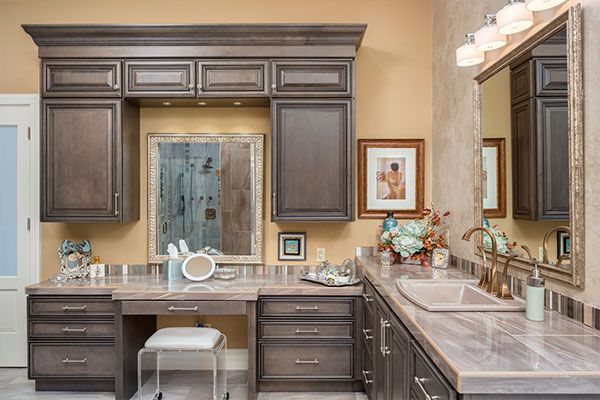 dark wooden bathroom cabinets and modern sink design. 