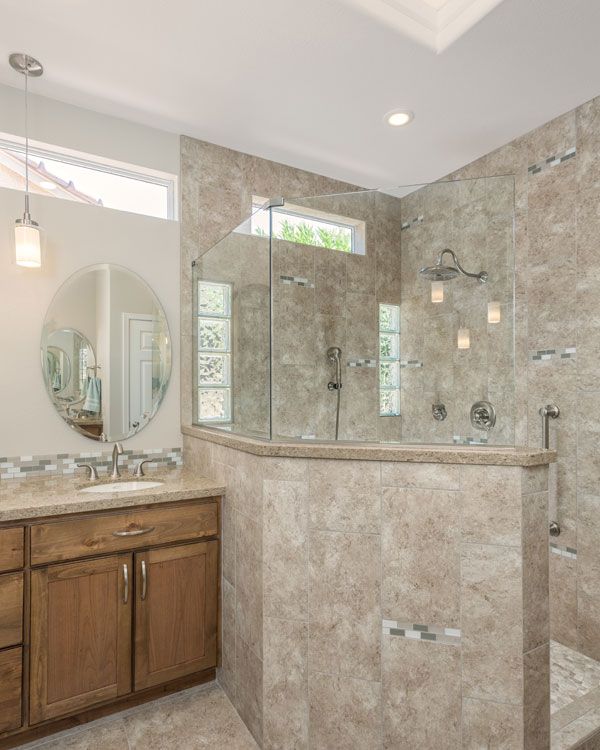 Half glass shower walls with light colored bathroom walls. 