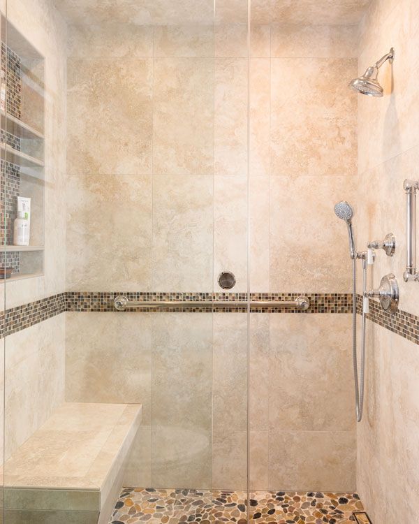 Large bathroom shower with stone flooring. 