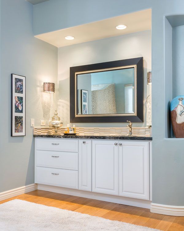 Light blue bathroom walls and white cabinets. 