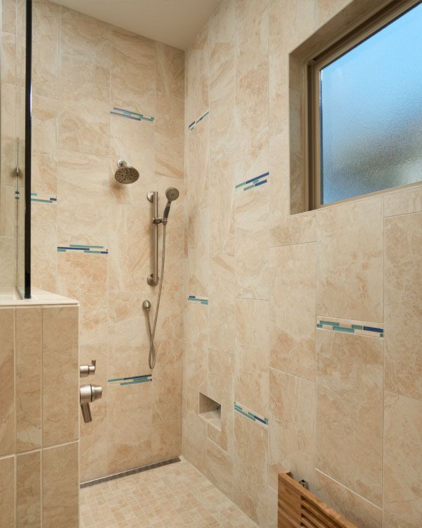Large light colored bathroom shower. 