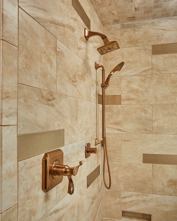 copper colored shower head and handles. 