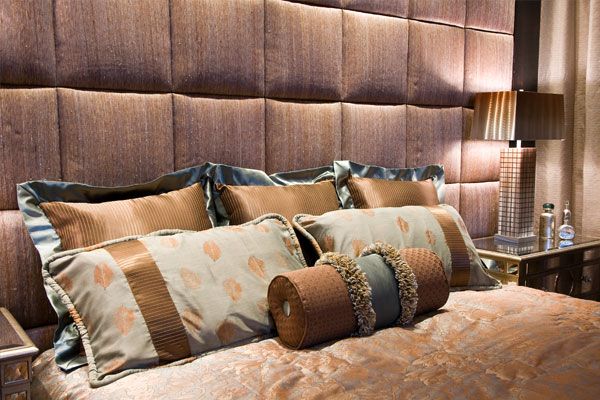 Designer pillows on bed. 