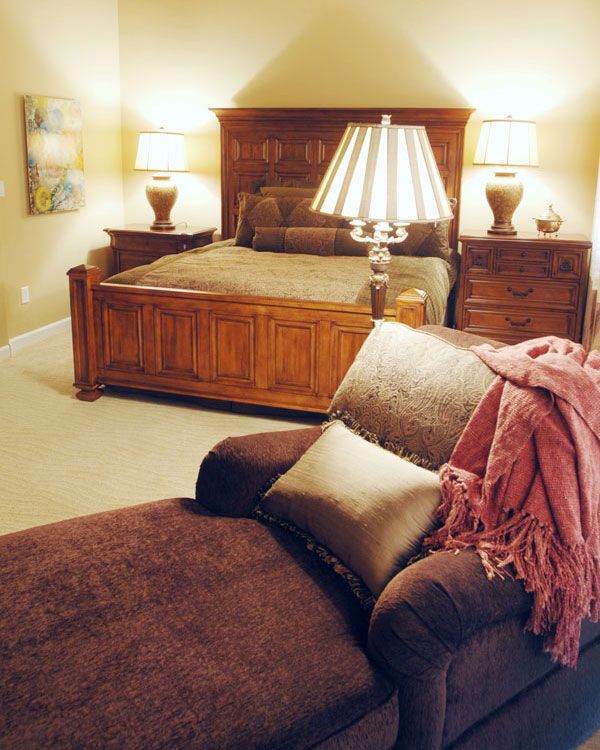 Bedroom with bright walls and seat with leg rest.