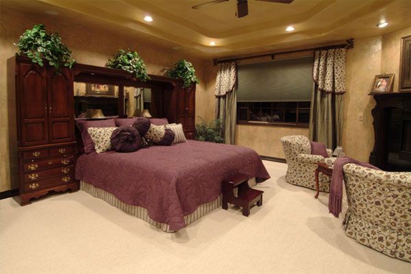 Carpeted bedroom with lights around the room on the ceiling 