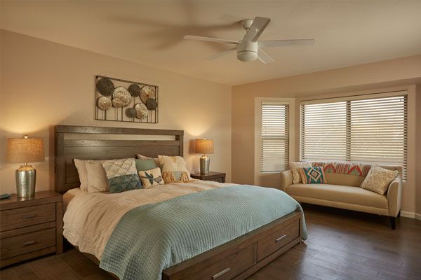 Wood floors with with a couch in a bedroom. 