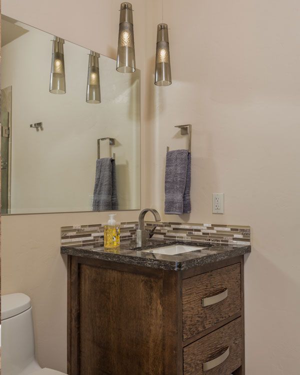 Powder room with light colored walls. 
