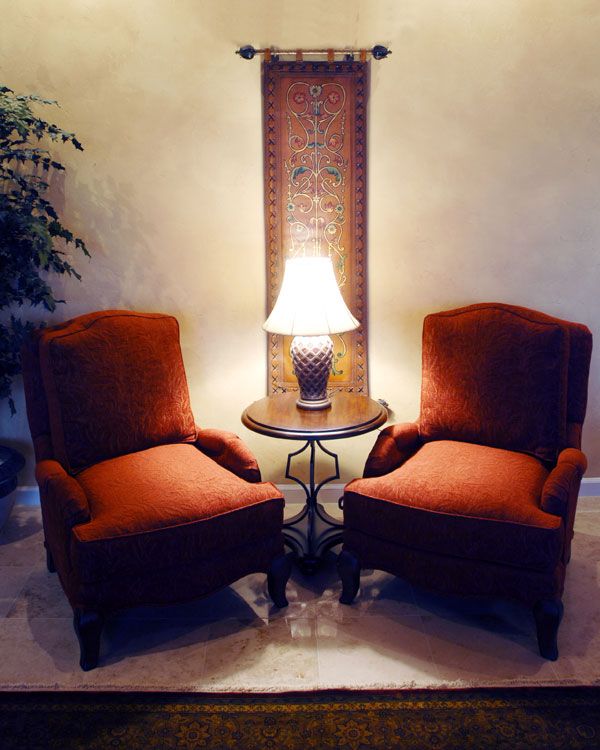 2 dark red seats with white walls in the back. 