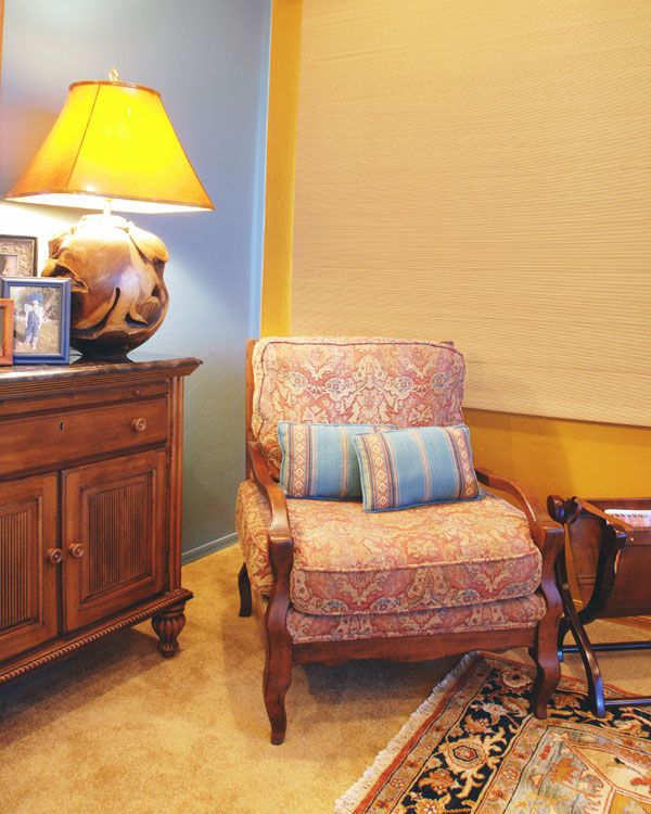 Yellow and blue walls with a rug. 