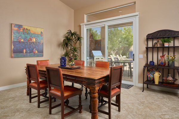 Light brown walls with dark red wood table. 