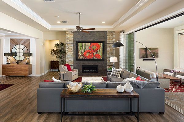Dark wood floors and a fireplace with white walls. 