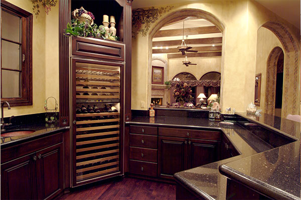 Dark wooden kitchen cabinets and a wine cabinet.