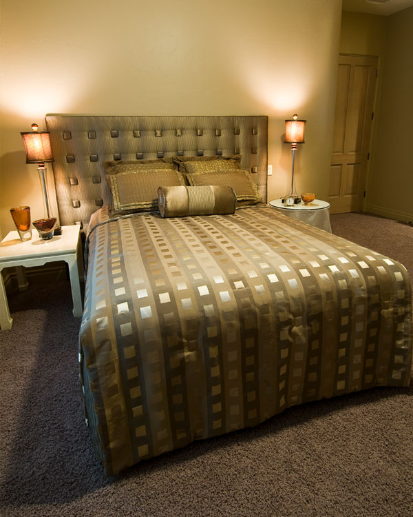 Bedroom with dark carpet and light green walls.