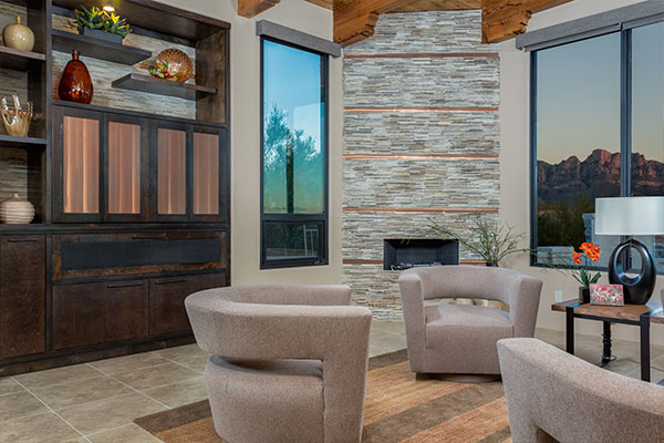 tile floors with dark wood furniture and small fireplace in the center.