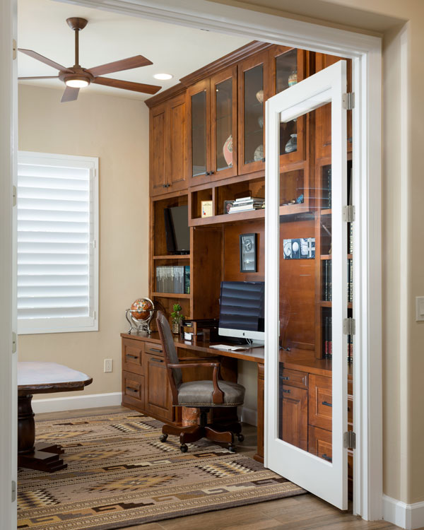 Office with light colored walls and rug.