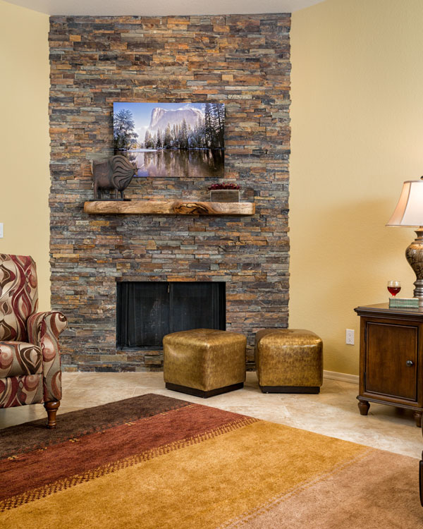 Medium sized fireplace with painting above it.